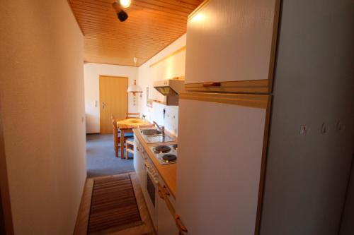 a kitchen with a refrigerator and a dining room at Ferienhof Ralf Becker Nr4 in Dänschendorf
