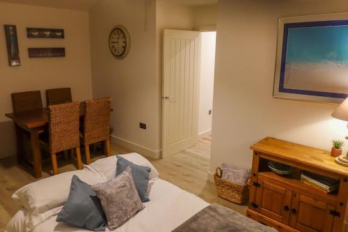 a living room with a television and a dining room table at Sennen Cove Retreat in Sennen Cove