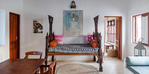 a living room with a chair and a table at Jua House in Lamu