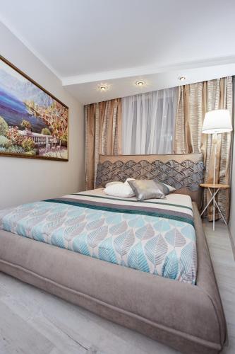 a bedroom with a large bed in a room at Langery Residence Central Apartments in Odesa