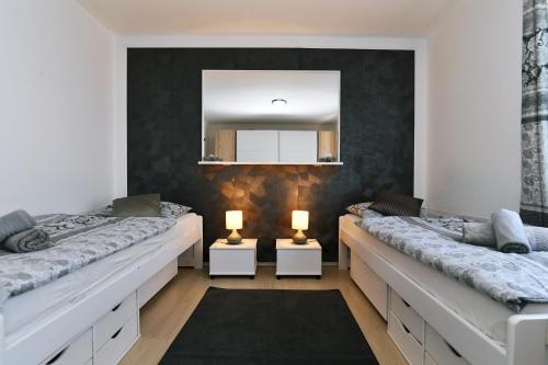 a room with two beds and a mirror at Apartman SÙŠANJ in Opatija