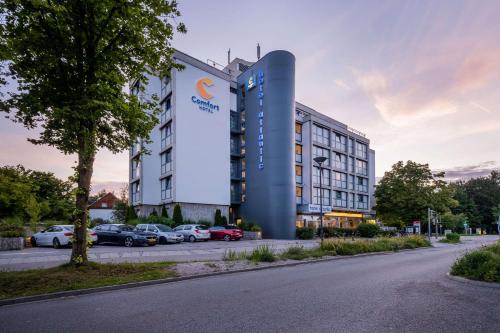 a rendering of a hotel with cars parked in a parking lot at Comfort Hotel Atlantic Muenchen Sued in Ottobrunn