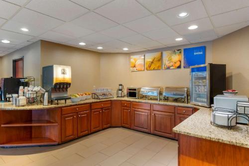 a kitchen with wooden cabinets and a counter top at Comfort Inn in Pickerington