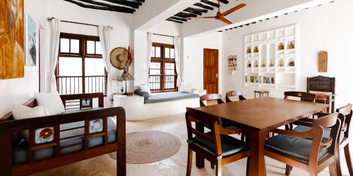 a dining room with a table and chairs at Jua House in Lamu
