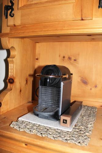 a toaster oven sitting inside of a cabinet at Chalet Hagenbächli in Schwarzsee
