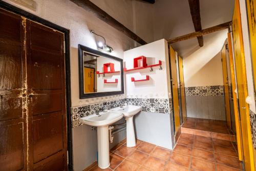 a bathroom with a sink and a mirror at Amaka House in Granada