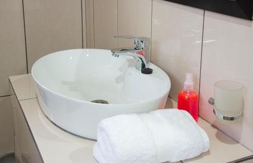 a bathroom with a white sink and a towel at Bongan Safari Lodge in Mbabat