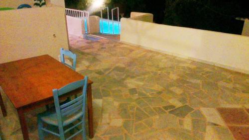 a table and two chairs and a table and a table and a table at Villa Konaki in Grammatiko