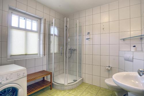 a bathroom with a shower and a toilet and a sink at Gotland 2 in Zingst