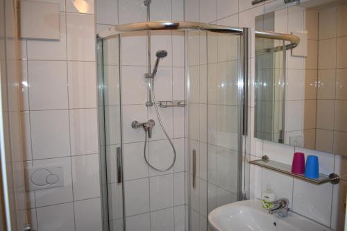 a bathroom with a shower and a sink and a shower at Am Kurpark " Nr 812" in Baabe