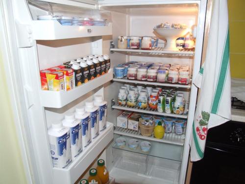 an open refrigerator filled with lots of food and drinks at B&B Simona in Sorbolo