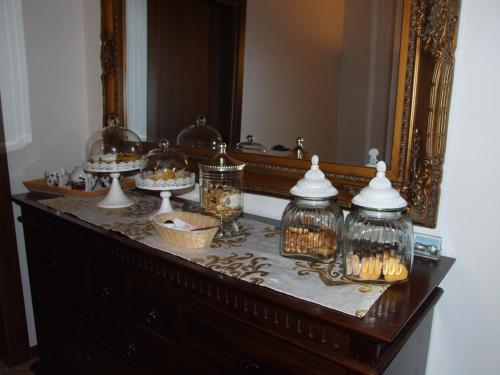 a table with a mirror and some candles on it at B&B Simona in Sorbolo