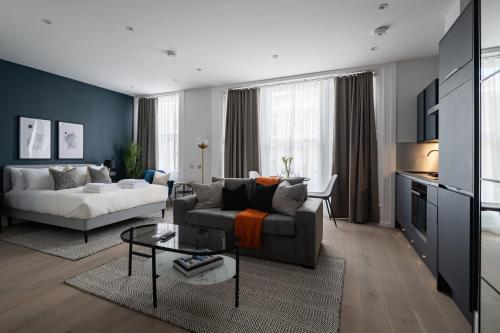 a living room with a couch and a table at No. 2 Queensberry Place by Stayo in London