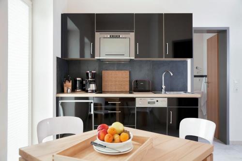 a kitchen with a table with a bowl of fruit on it at Lachmöwe - 29741 in Haffkrug