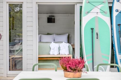 a bed on a screened in porch with a surfboard at 4 Bedroom Archipelago Retreat in Tranholmen