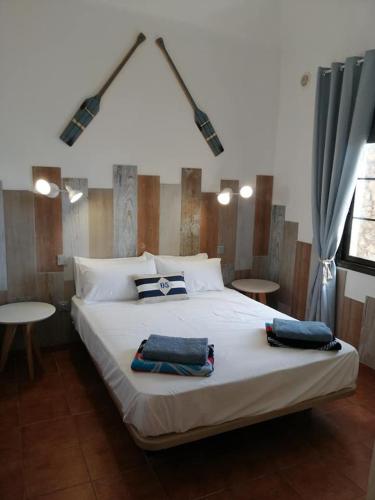 a bedroom with a large bed with two towels on it at Casa Castillo in Caleta De Fuste