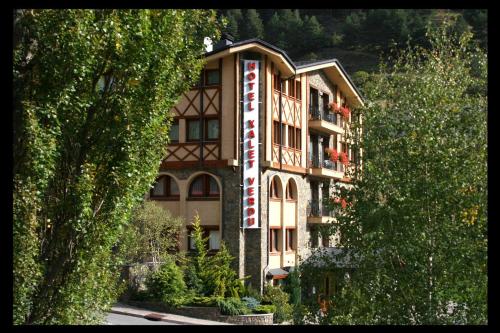 a building with a sign on the side of it at Hotel Xalet Verdú in Arinsal
