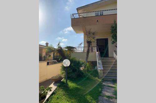 a house with a staircase leading up to it at Villa Anna Paola in Casal Palocco