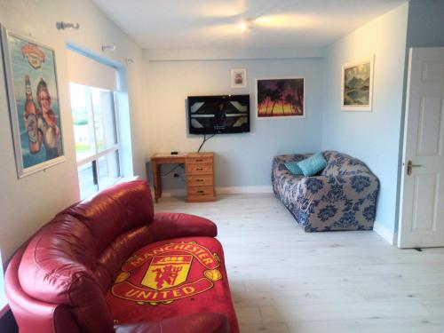 a living room with a couch and a chair at Atlantic Point Stunning Sea View in Bundoran