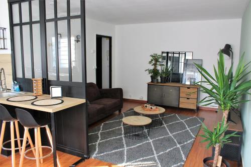 a living room with a couch and a table at Chez Jo in Lens