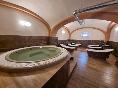 a large bathroom with a jacuzzi tub and toilets at Penzión SESSLER *** in Trnava