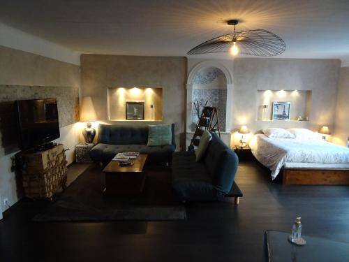 a large living room with a bed and a couch at La Halte in Jeuxey