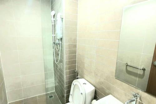 a small bathroom with a toilet and a shower at Kozi Square New Apartment Cozy Home 9A in Kuching