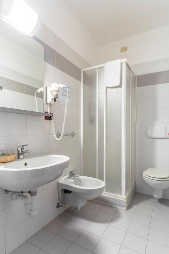 a bathroom with a sink and a shower and a toilet at Il Seminario in Alba