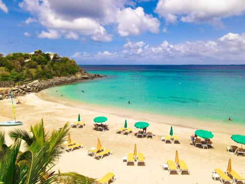 a beach with chairs and umbrellas and the ocean at Villa SEA VIEW, 5 min from the beach, overlooking the caribbean sea, private pool in Friar's Bay