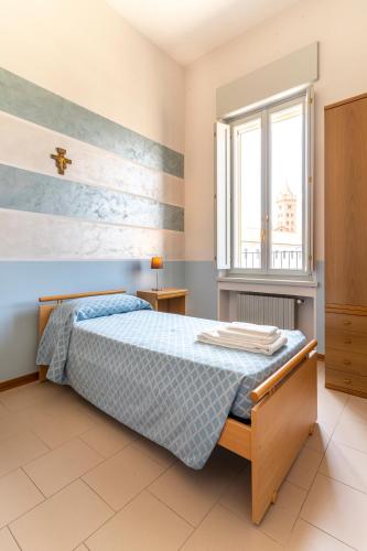 a bedroom with a bed and a window at Il Seminario in Alba