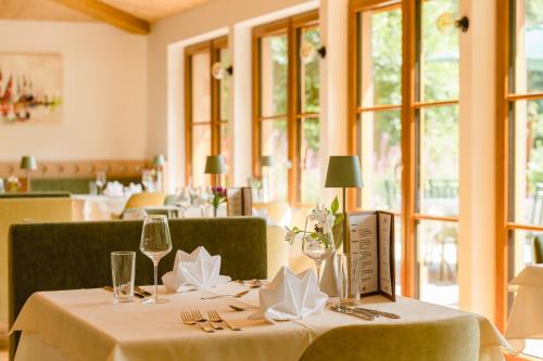 a dining room with a table with glasses and napkins at Landhotel Hochlackenhof in Fuschl am See
