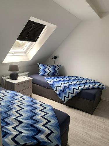 a bedroom with two beds and a window at HT Appartement Nr 1 in Greppin