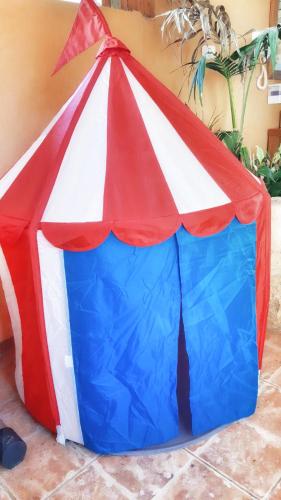 a red white and blue play tent on the ground at 19th Century Magical House in Galilee in ‘Eilabūn