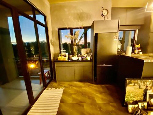 a room with a kitchen with a view of the city at Faizal Madhi Homestay in Kuching