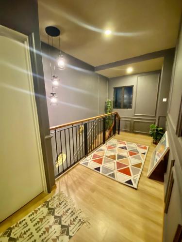 a room with a balcony with a rug on the floor at Faizal Madhi Homestay in Kuching