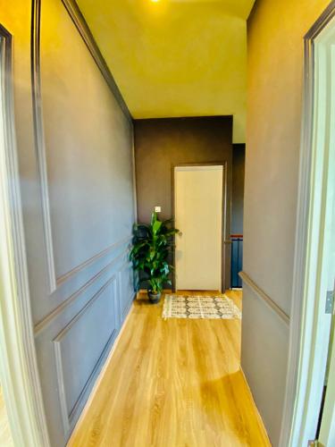 an empty hallway with a door and a plant at Faizal Madhi Homestay in Kuching