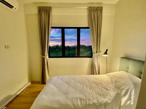 a bedroom with a bed and a large window at Faizal Madhi Homestay in Kuching