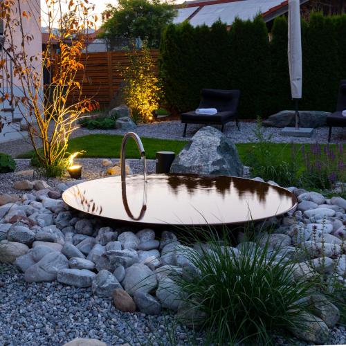 a surfboard sitting on top of a pile of rocks at Hotel Bergidyll in Pfronten
