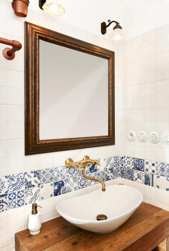a bathroom with a white sink and a mirror at Vinný sklípek Blatnice in Blatnice