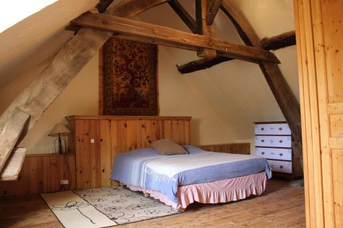 a bedroom with a bed in an attic at Bras D’Or Rural Gite cottage by farms & lakes. in Bais