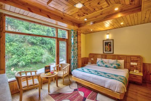 Ένα ή περισσότερα κρεβάτια σε δωμάτιο στο The Holiday Resorts and Cottages