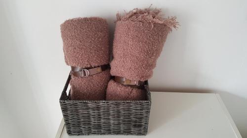 a pair of pink boots sitting in a basket at Green Wood Apartament Stara Ochota in Warsaw
