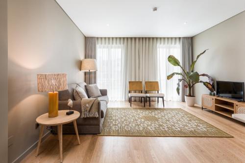 a living room with a couch and a table at Legends House by Sweet Porto in Porto