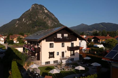 an aerial view of a hotel with a mountain in the background at Hotel Bergidyll in Pfronten