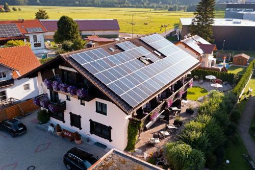 an image of a house with solar panels on the roof at Hotel Bergidyll in Pfronten