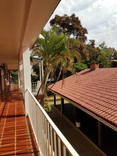 a balcony of a house with a roof at Hotel AATRAC Iguazú in Puerto Iguazú