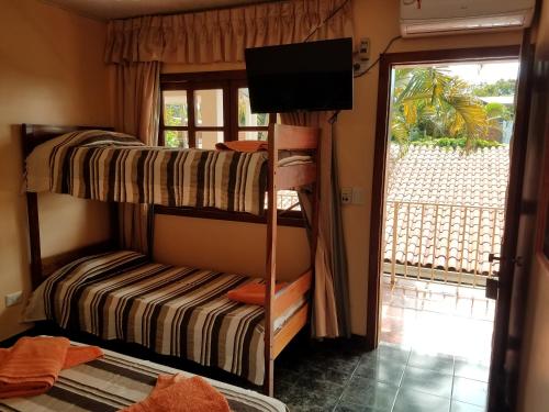 a room with two bunk beds and a window at Hotel AATRAC Iguazú in Puerto Iguazú