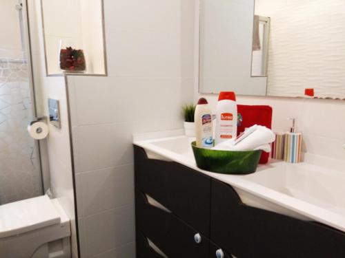 a bathroom with a sink and a toilet and a mirror at Aixula Lekeitio - Garaje opcional, reformado y céntrico in Lekeitio