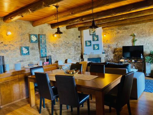 a dining room with a table and a couch at Casa do Caminho do Monte in Arcos de Valdevez