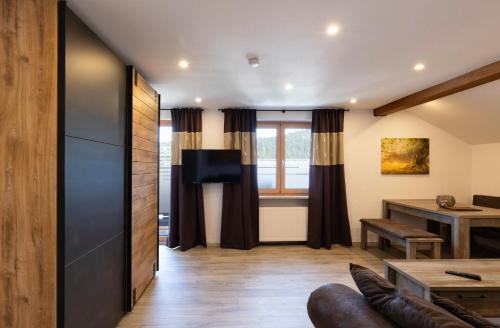 a living room with a couch and a table at Hotel Bergidyll in Pfronten